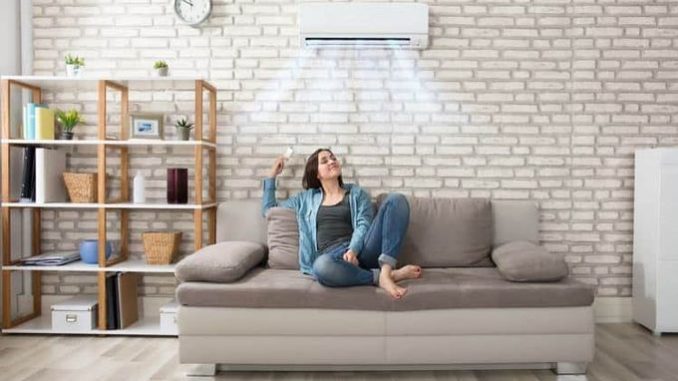 Woman-relaxing-under-the-air-conditioner